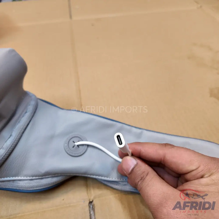 A gray fabric neck massager with a USB-C charging cable.