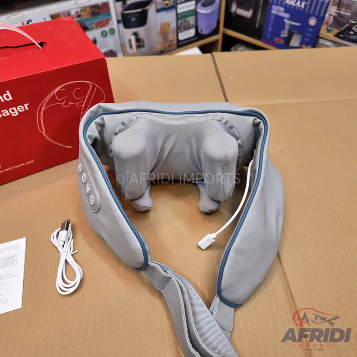 Grey neck and back massager with control buttons and a power cord.