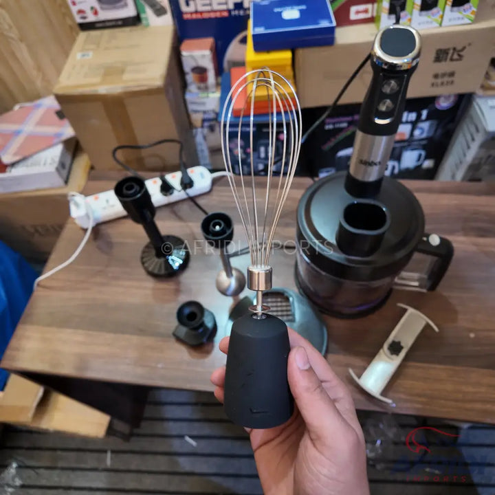 A multi-functional immersion blender set with various attachments, including a whisk, chopper, and processing bowl.