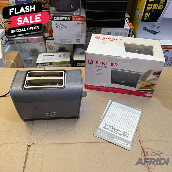 A gray two-slice toaster with a power cord, accompanied by its packaging and instruction manual.