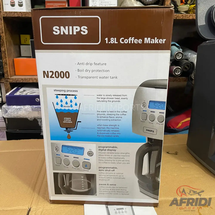 A boxed coffee maker with a 1.8-liter capacity, featuring an anti-drip function, boil-dry protection, a transparent water tank, a programmable digital display, and auto shut-off.