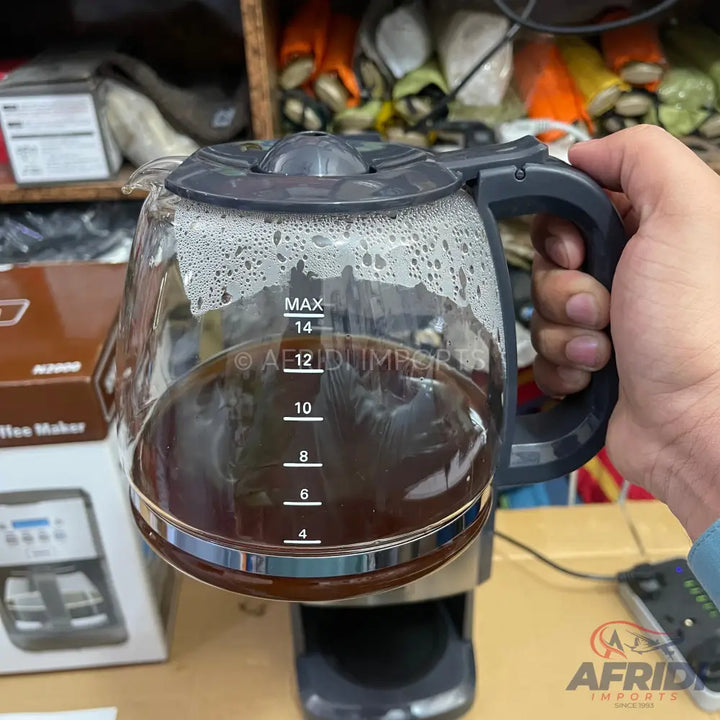 Glass coffee pot with a dark handle, lid, and a scale indicating liquid levels from 4 to 14.