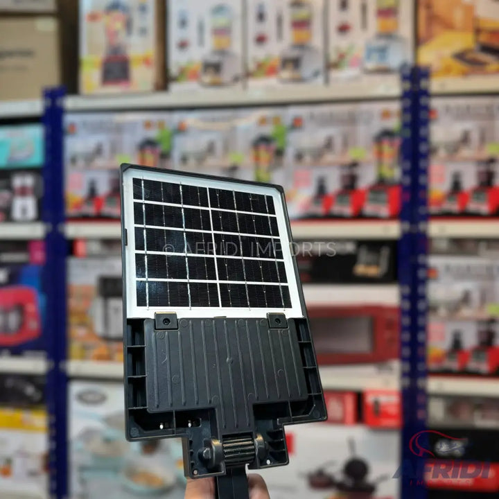 A black solar-powered outdoor light fixture with a rectangular panel of photovoltaic cells.
