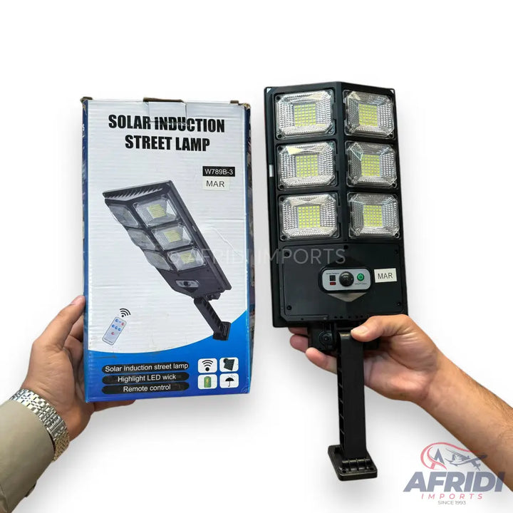 A solar-powered street lamp with six LED panels and a remote control.