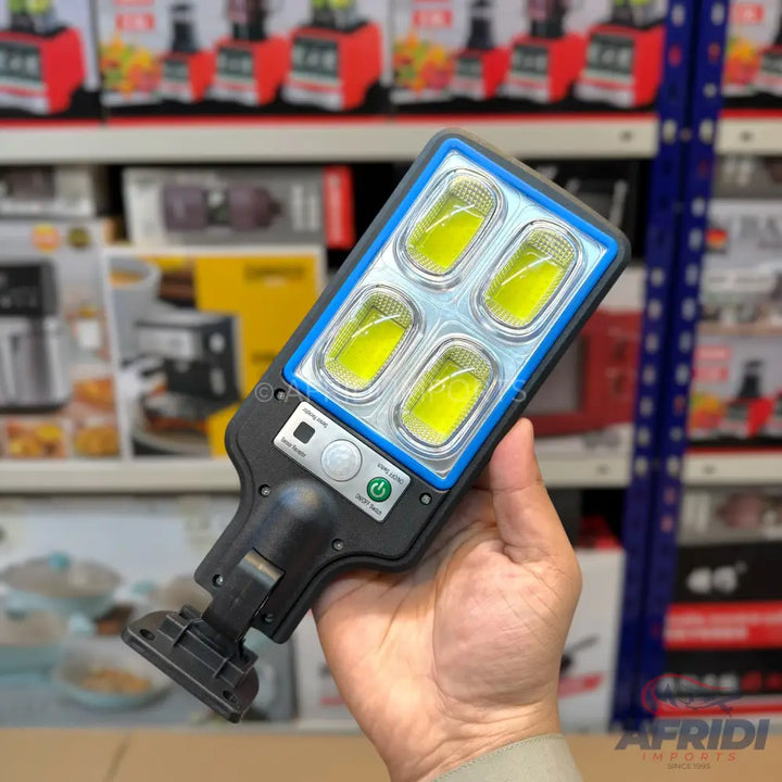 Black solar-powered LED floodlight with a motion sensor.
