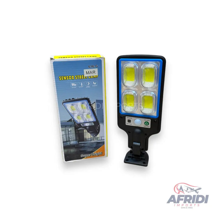 Black solar street light with four bright LED panels and a motion sensor.