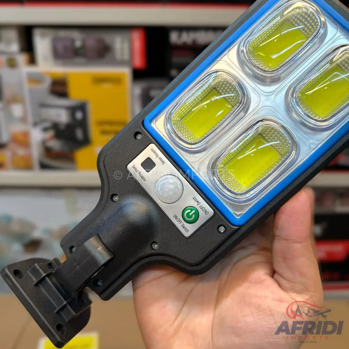 Black and blue solar-powered LED floodlight with motion sensor.