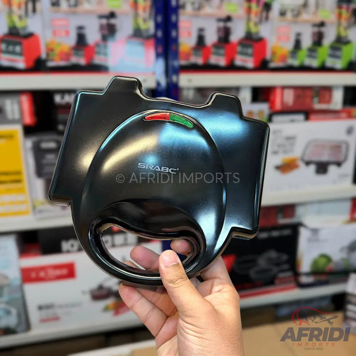 A black electric sandwich maker with red and green indicator lights.