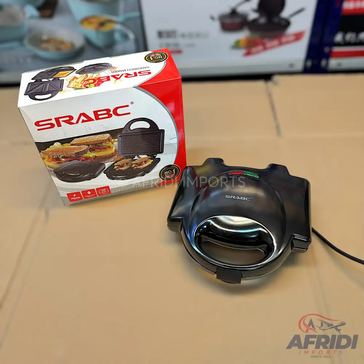 Black electric sandwich maker with interchangeable plates for grilling and waffles.