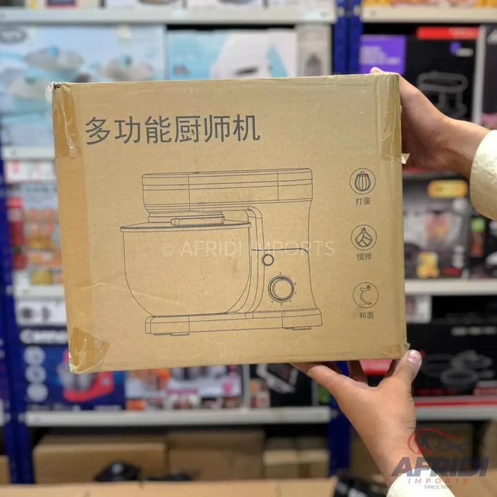 Cardboard box for a stand mixer, with an illustration of the appliance and its functions.