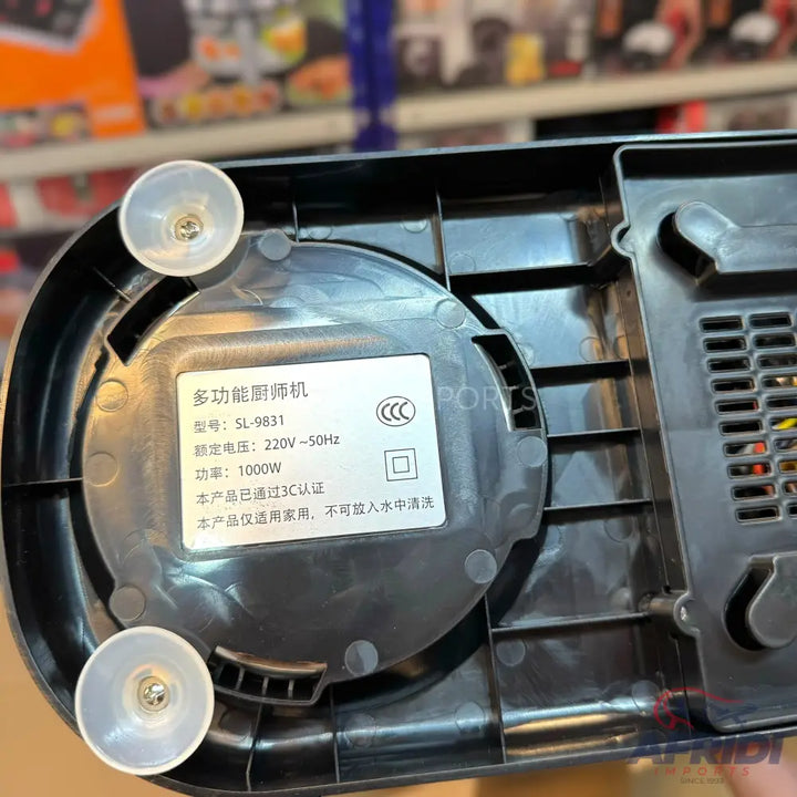 Underside of a black kitchen appliance with a label showing its model number, voltage, and power.