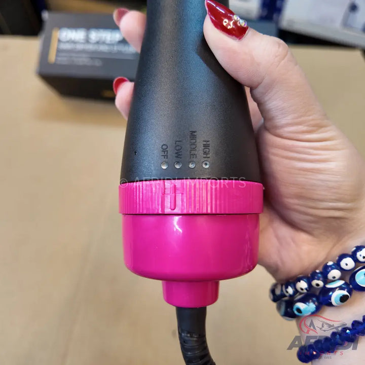 Black and pink hot air brush with adjustable heat settings.