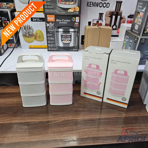 Two three-tiered stackable lunch boxes with carrying handles, one in light grey and one in pink.