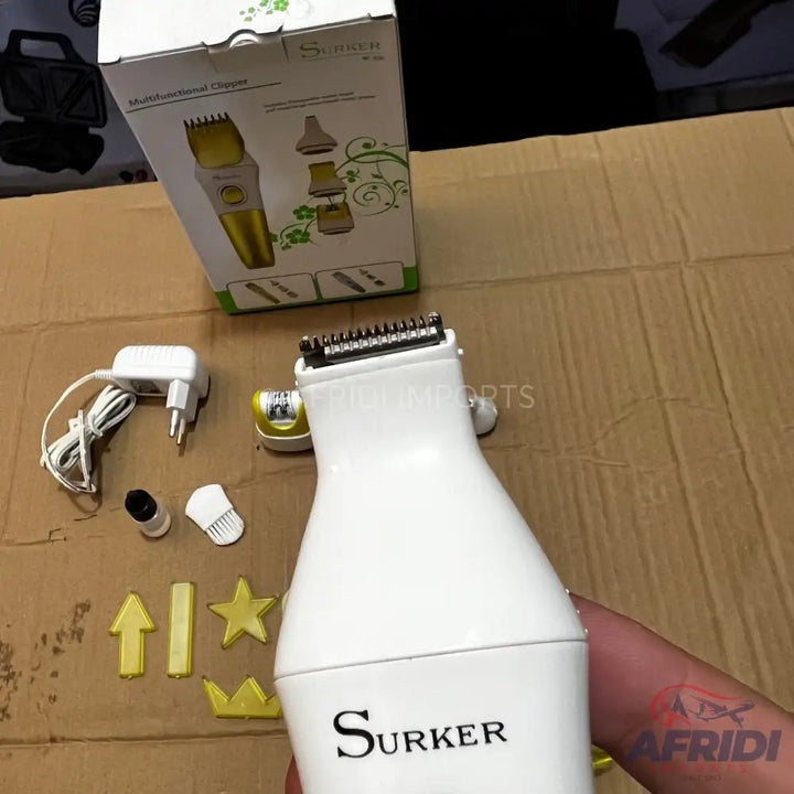 A white electric hair trimmer with a gold-colored base, including multiple attachments and a charger.