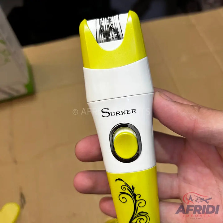 A handheld electric epilator with a yellow and white casing and a black floral design.