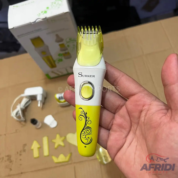 A yellow and white electric hair clipper with a clear plastic guard.