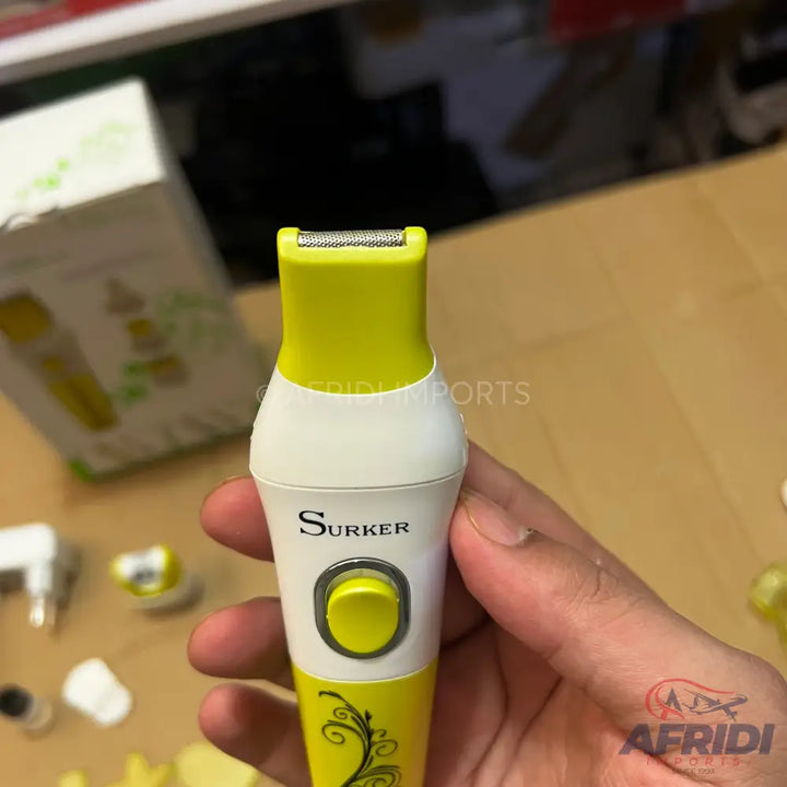 Yellow and white electric shaver with a single power button.