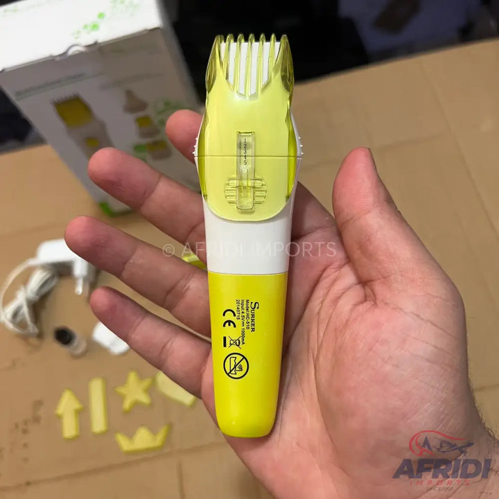 A yellow and white electric hair clipper with a transparent comb attachment.