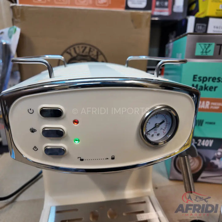 Cream-colored espresso maker with a pressure gauge and control buttons.