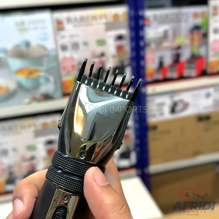 Handheld electric hair clipper with an adjustable guide comb.