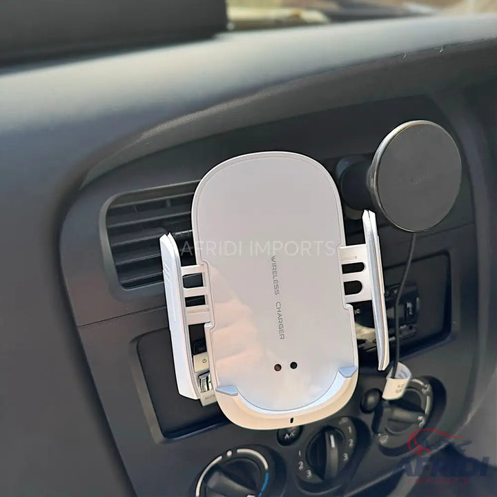 White car phone mount with wireless charging capabilities.