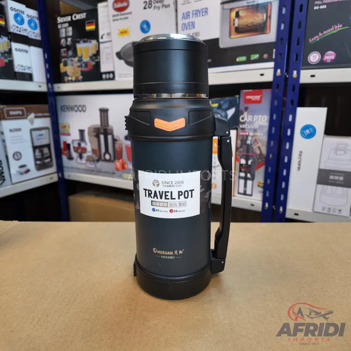 Black travel thermos with an orange accent and a side handle.