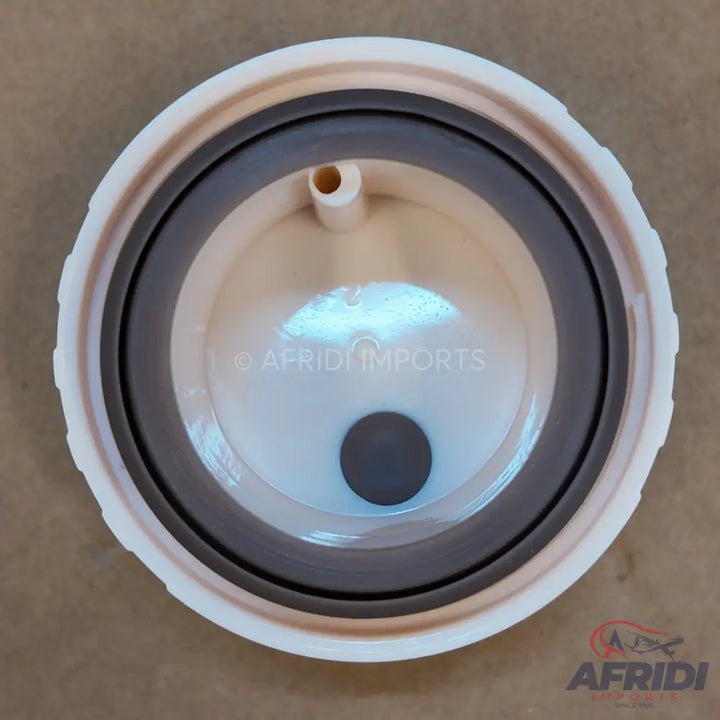 A cream-colored circular plastic lid with a dark gray rubber seal, a small spout, and a central circular opening.
