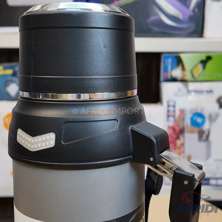 Black and gray insulated beverage dispenser with a handle and push-button release.