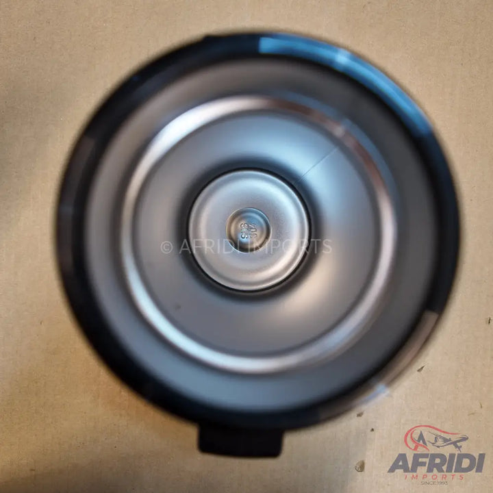 The interior of a silver-colored insulated thermos or travel mug with a push-button stopper.