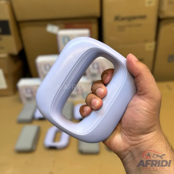 Purple plastic square-shaped door handle with a rounded grip.
