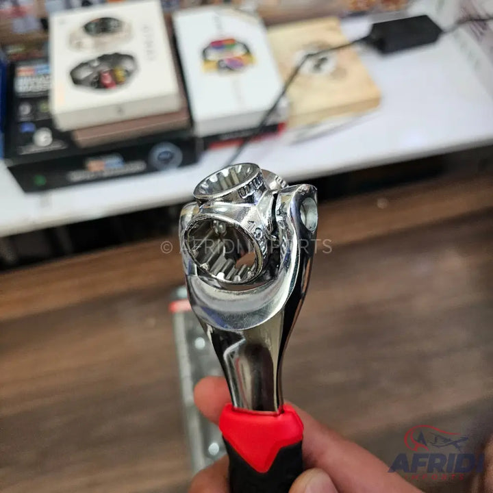 A multi-socket universal wrench with a black and red ergonomic handle.