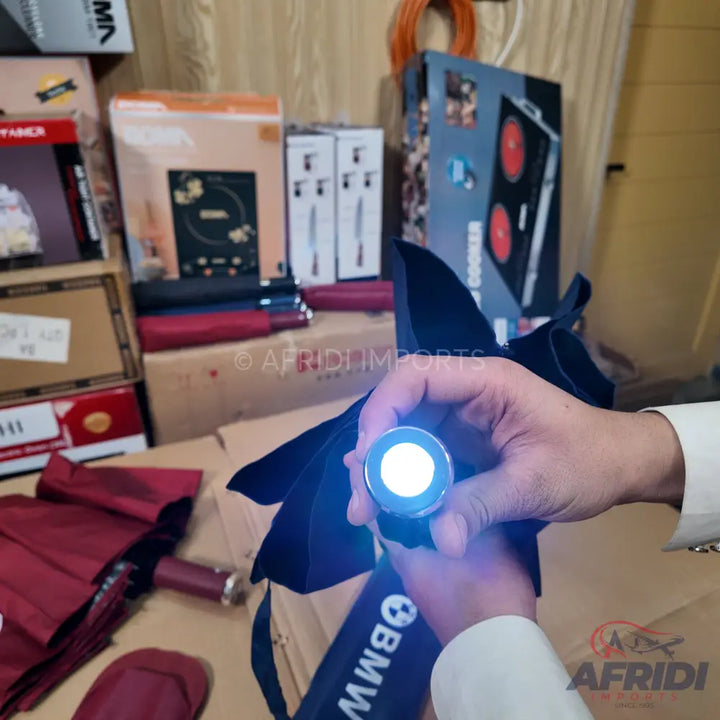 A person holding a glowing flashlight.