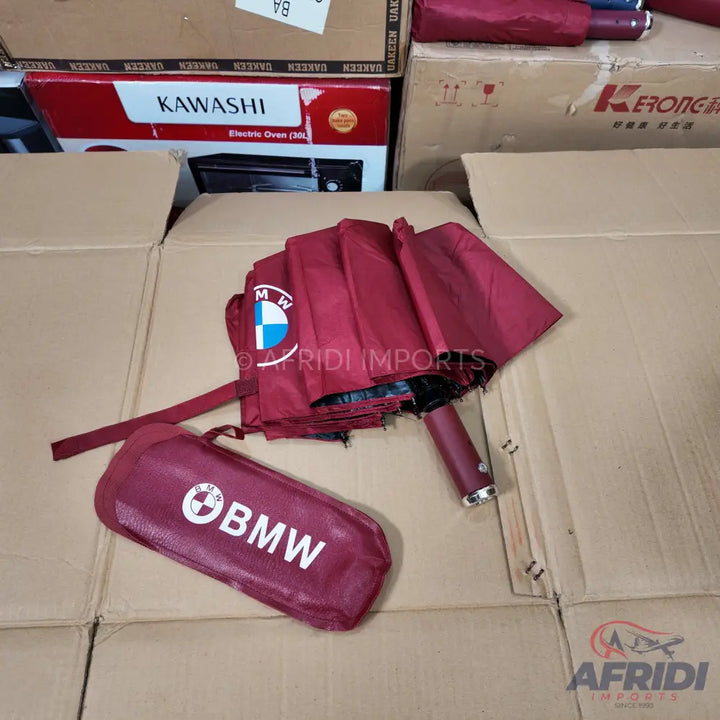 Maroon BMW-branded folding umbrella with a matching sleeve.