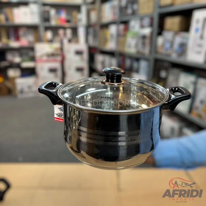 A stainless steel cooking pot with a glass lid and black handles.
