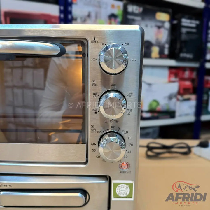 Stainless steel toaster oven with three control knobs.