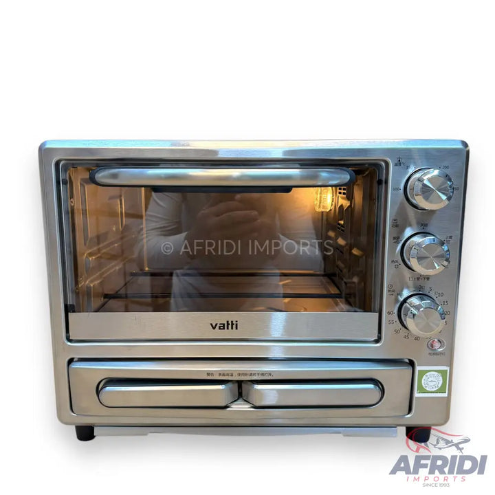 Stainless steel toaster oven with multiple control knobs and a lower warming drawer.