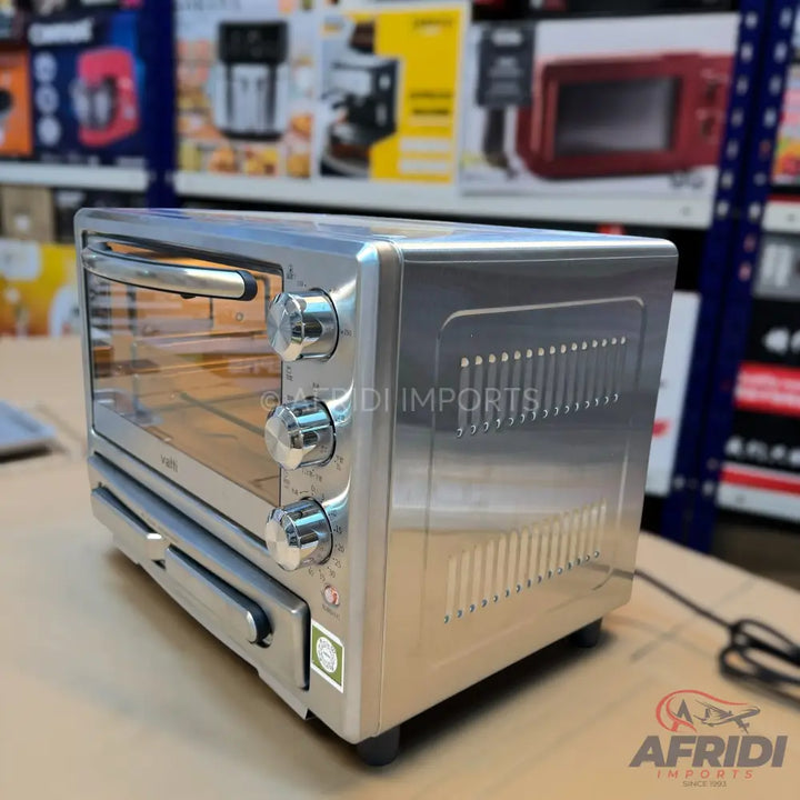 Stainless steel toaster oven with three control knobs and a pull-out crumb tray.
