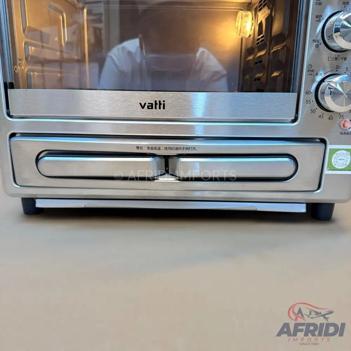 Stainless steel toaster oven with a pull-out crumb tray.