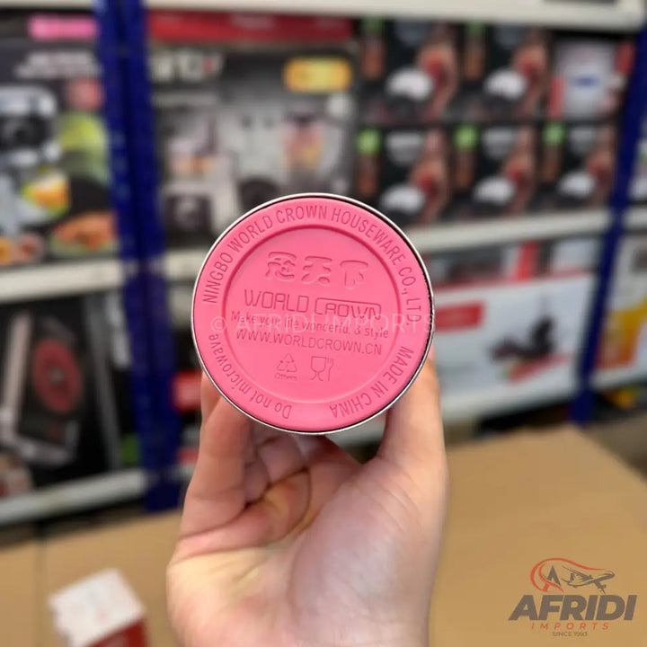 A pink, cylindrical thermos or tumbler with a textured bottom.
