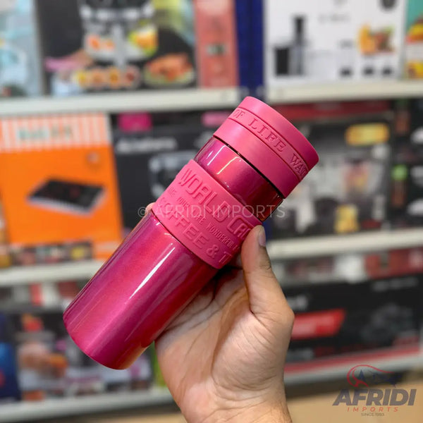 Hot pink insulated travel mug with a matching grip.
