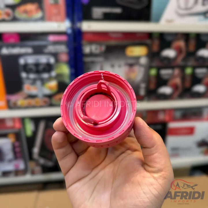 Pink plastic water bottle cap with an internal strainer.