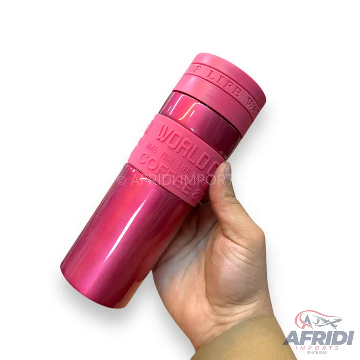 A shiny, metallic pink, insulated travel mug with a silicone grip band.
