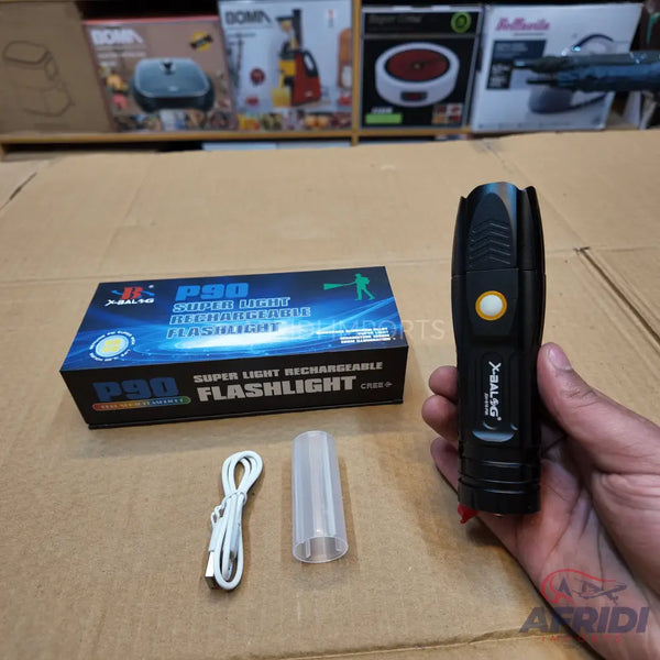 Black rechargeable LED flashlight with a yellow power button, accompanied by its packaging box, a USB charging cable, and a translucent white diffuser.