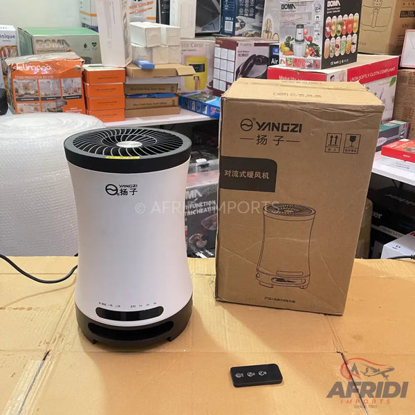 White and black cylindrical convection heater with a remote control.
