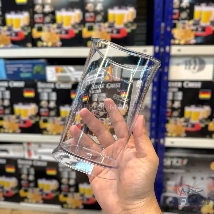 A clear plastic measuring cup with a handle.