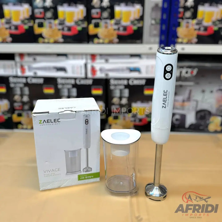 White immersion blender with a measuring cup and its retail packaging.