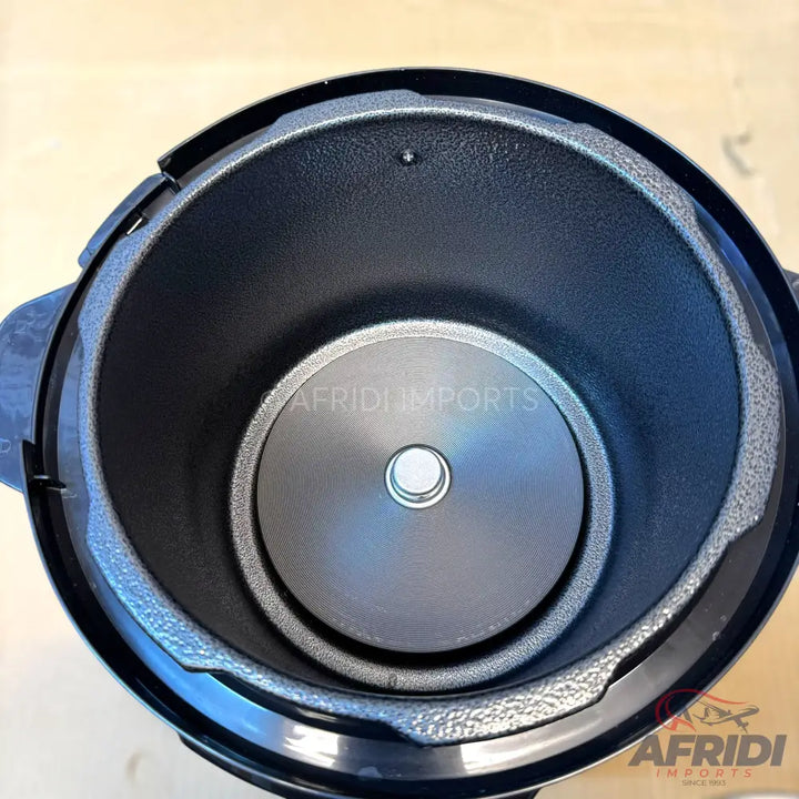 An empty, black, non-stick inner pot of an electric pressure cooker.