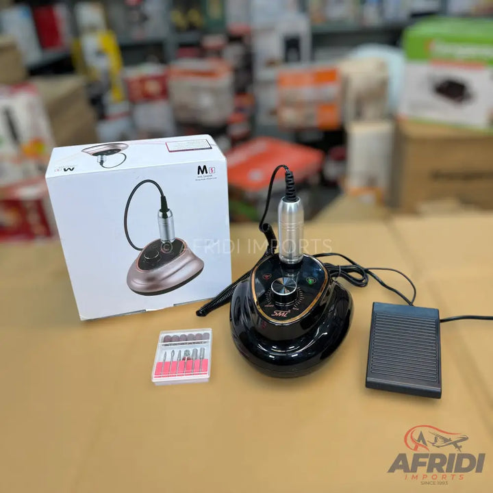 Electric nail drill machine with a foot pedal and a set of drill bits.