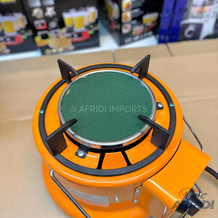 Orange portable gas stove with a green burner element.