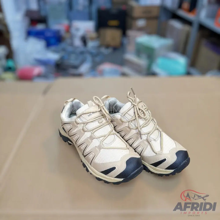 Pair of light-colored hiking shoes with dark accents.
